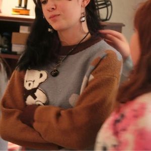 Blue, brown, white, and black teddy bear sweater